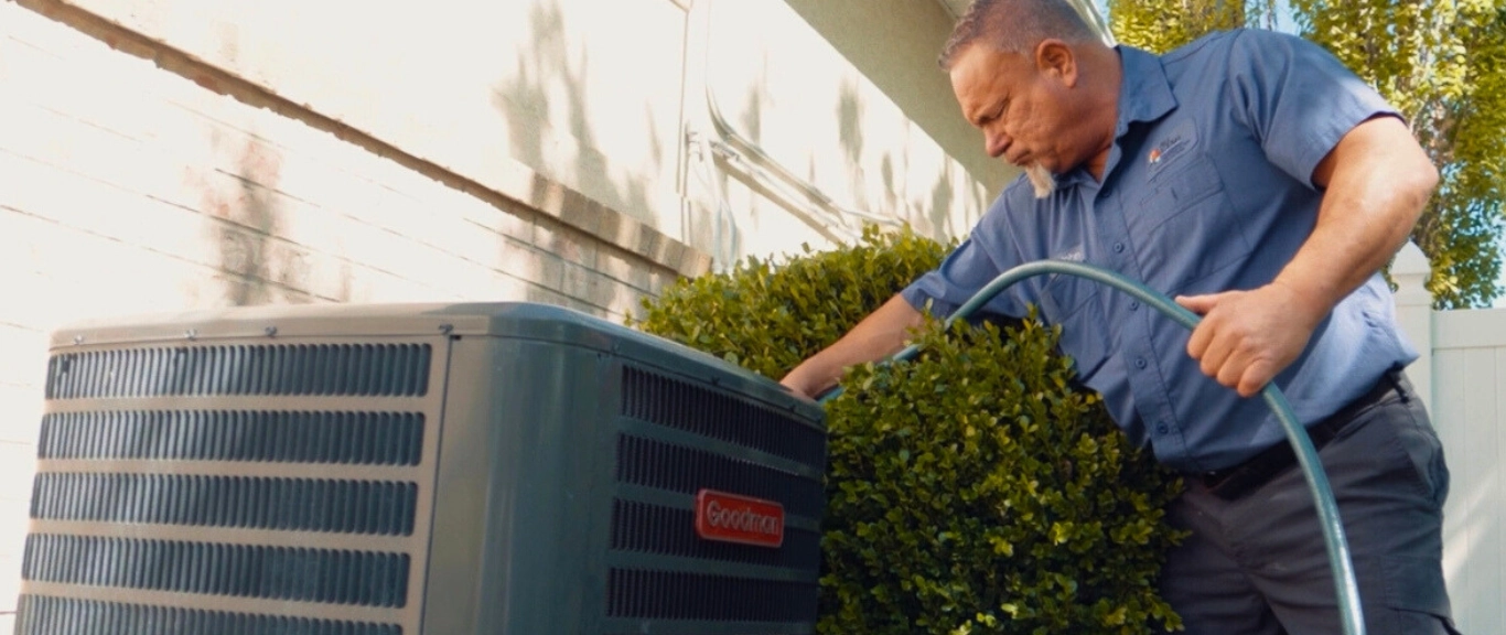 John cleaning with hose air conditioning unit maintenance